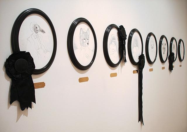 Ten 'Extinction Portraits' lined the back wall, each with a museum-style brass plaque underneath, stating the species name and extinction date for each piece Ten 'Extinction Portraits' lined the back wall, each with a museum-style brass plaque underneath, stating the species name and extinction date for each piece